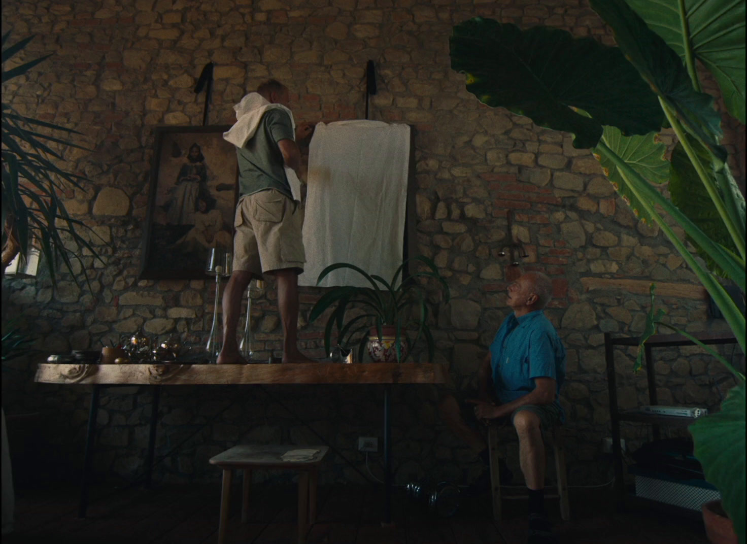 a man standing on top of a wooden table