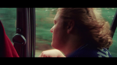 a woman looking out the window of a bus