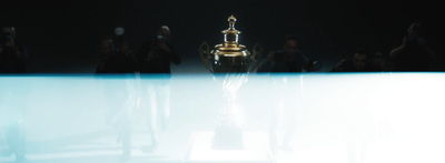 a group of people standing around a trophy