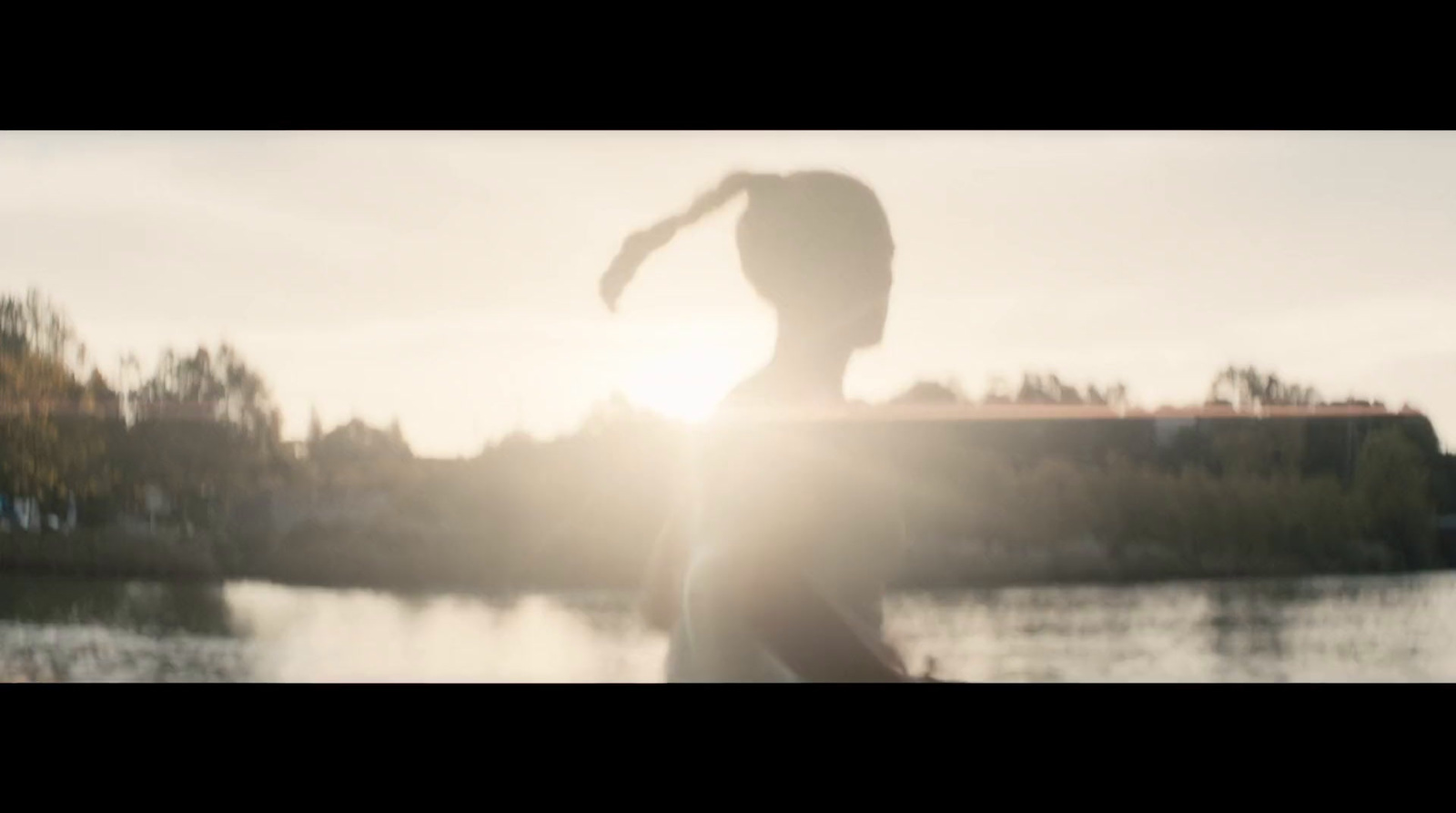 a blurry photo of a person standing in front of a lake