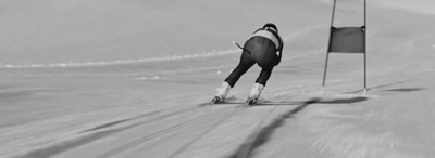 a man riding skis down a snow covered slope