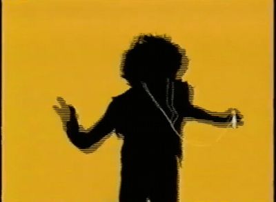 a silhouette of a person standing in front of a yellow background