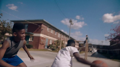 two young boys playing a game of basketball