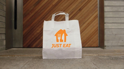 a white paper bag with a house and fork on it