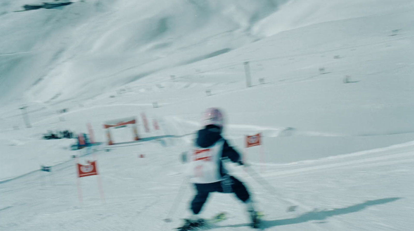 a man riding skis down a snow covered slope