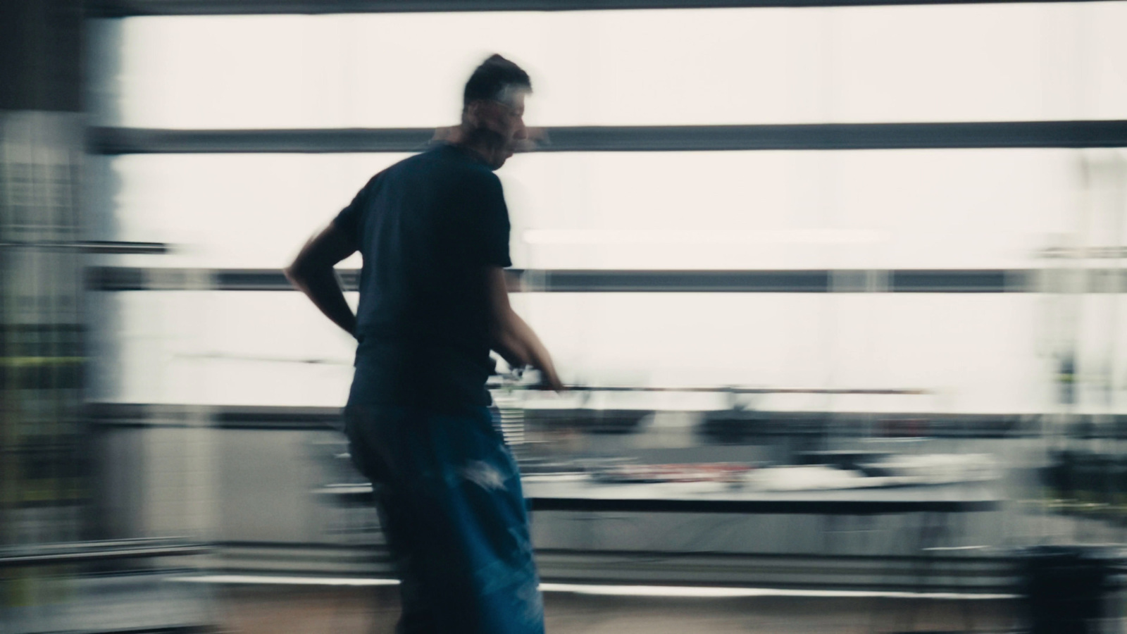 a blurry photo of a man standing in front of a window