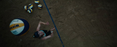 a woman laying on the ground next to a beach ball