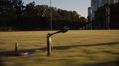 a man swinging a bat at a ball in a park