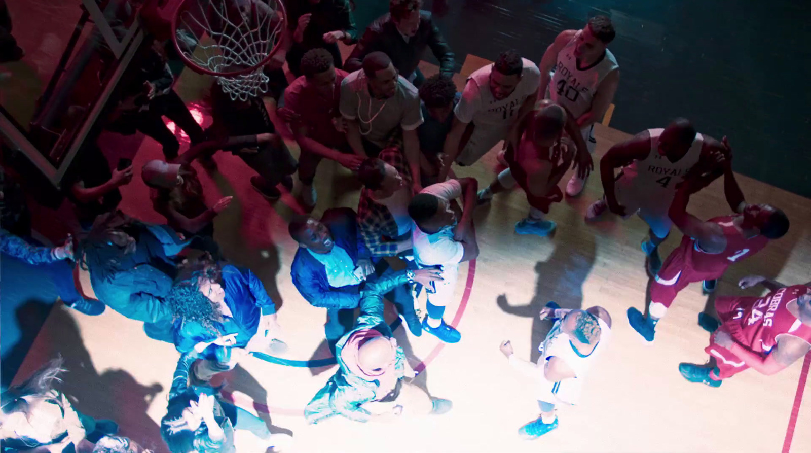 a group of people standing on top of a basketball court