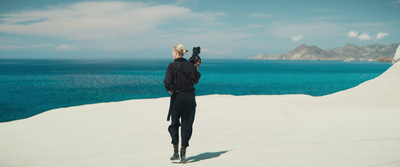 a person standing on top of a sandy hill