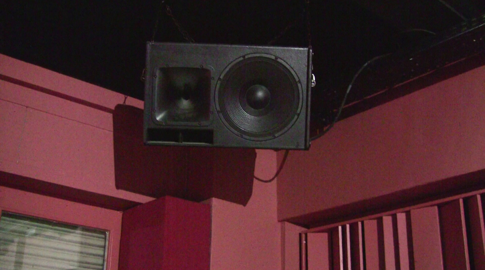 a speaker hanging from the side of a building