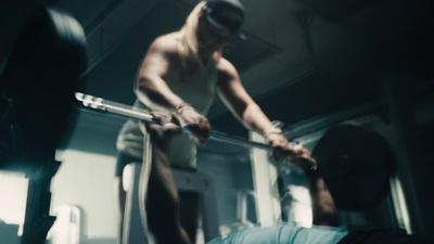 a man holding a bar in a gym