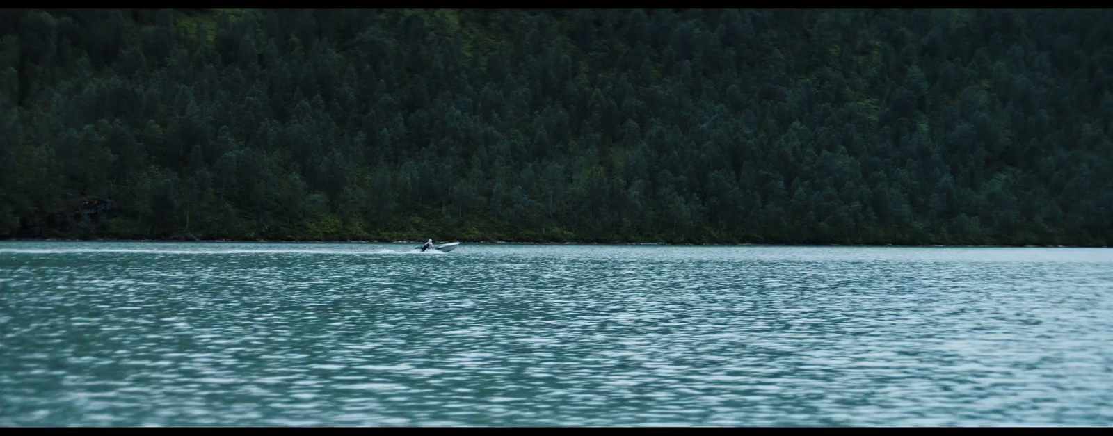 a lone boat in the middle of a large body of water