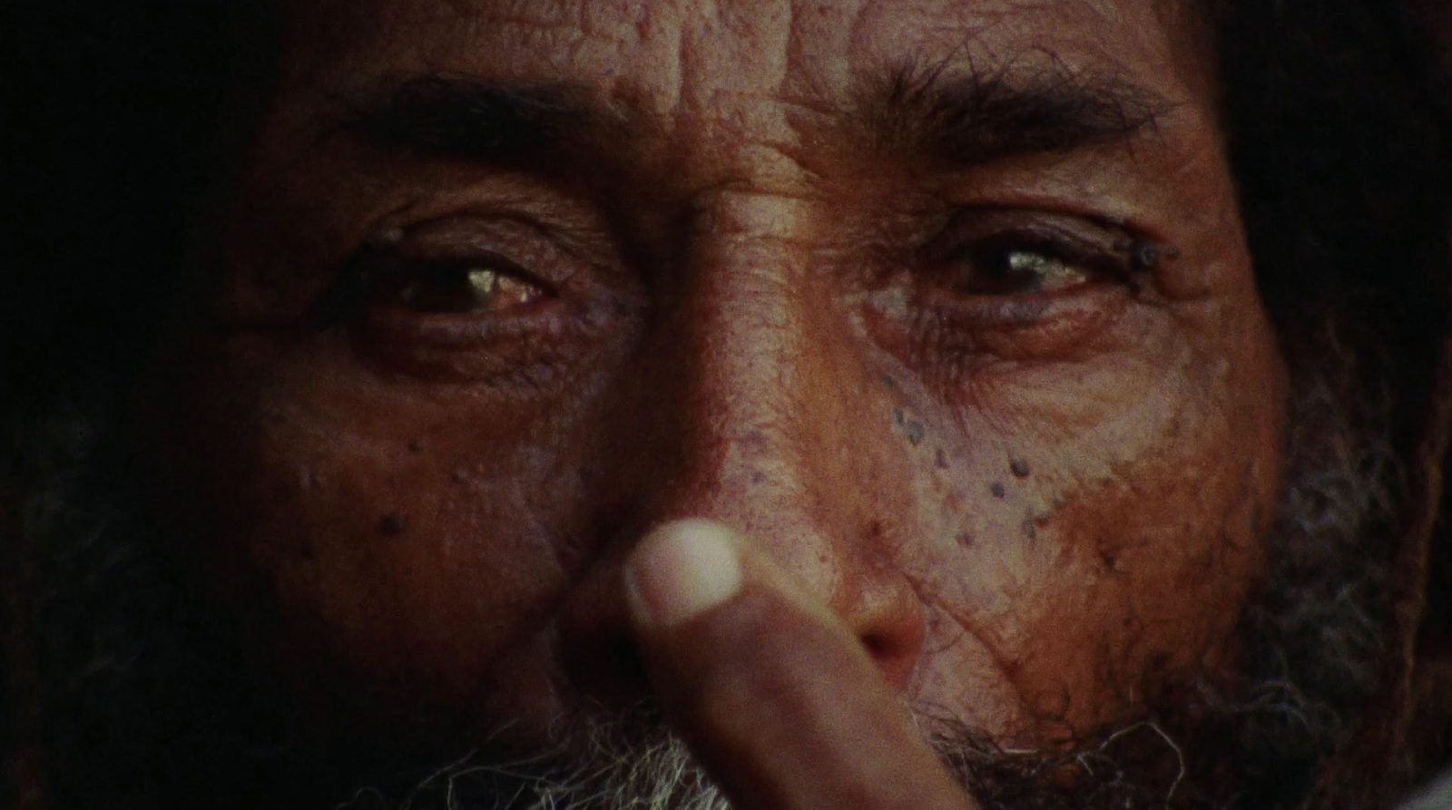 a close up of a man with a cigarette in his mouth