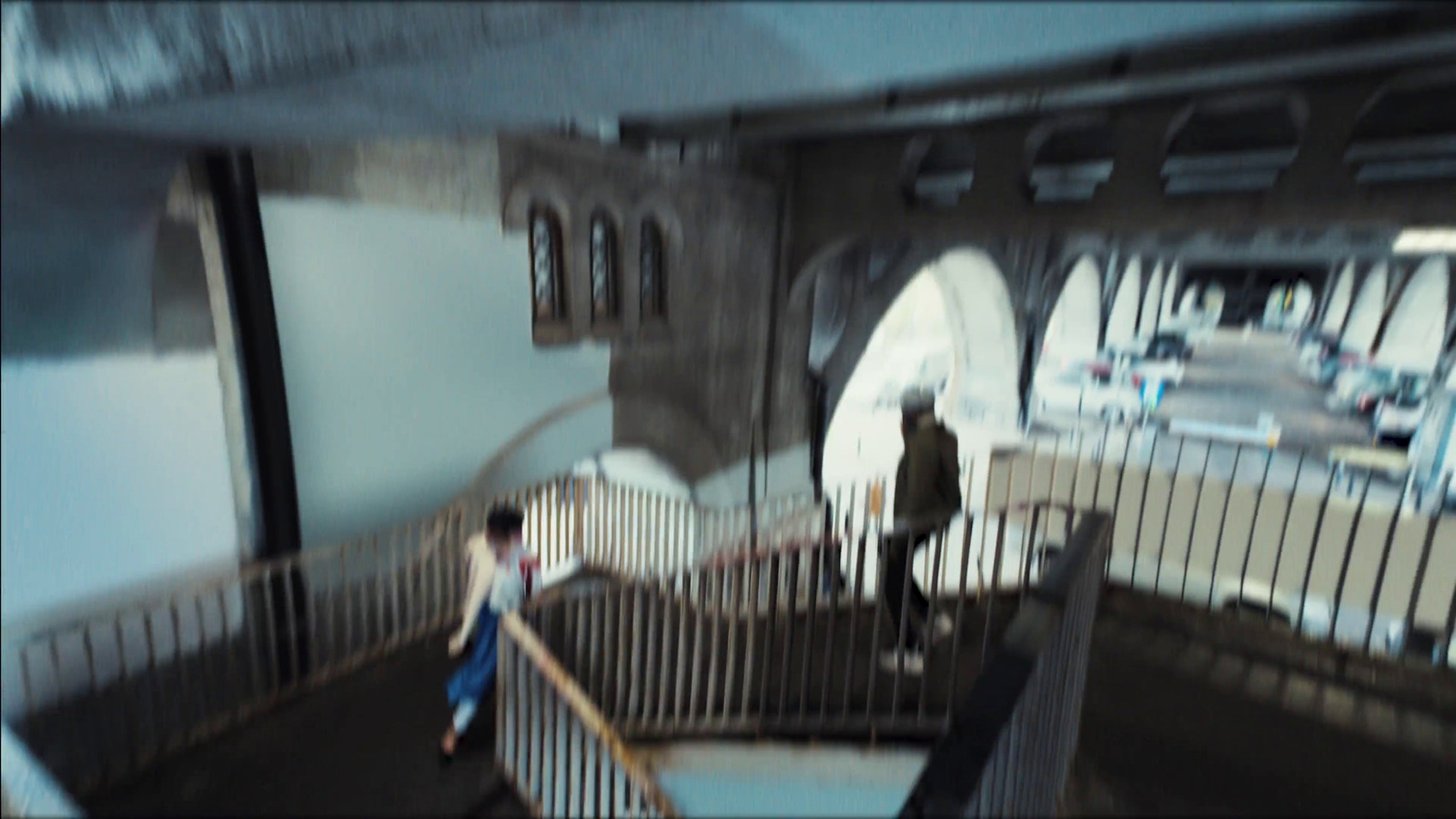 a blurry image of a person walking down a set of stairs