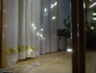 a window with a curtain and a string of lights on it