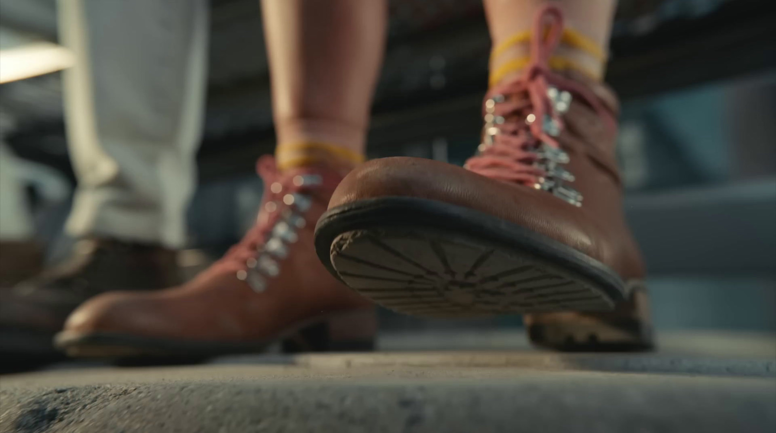 a close up of two people's feet wearing hiking boots