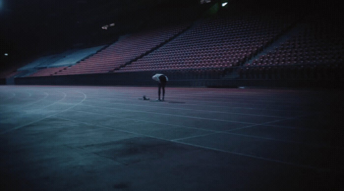 a person standing on a tennis court with a racquet