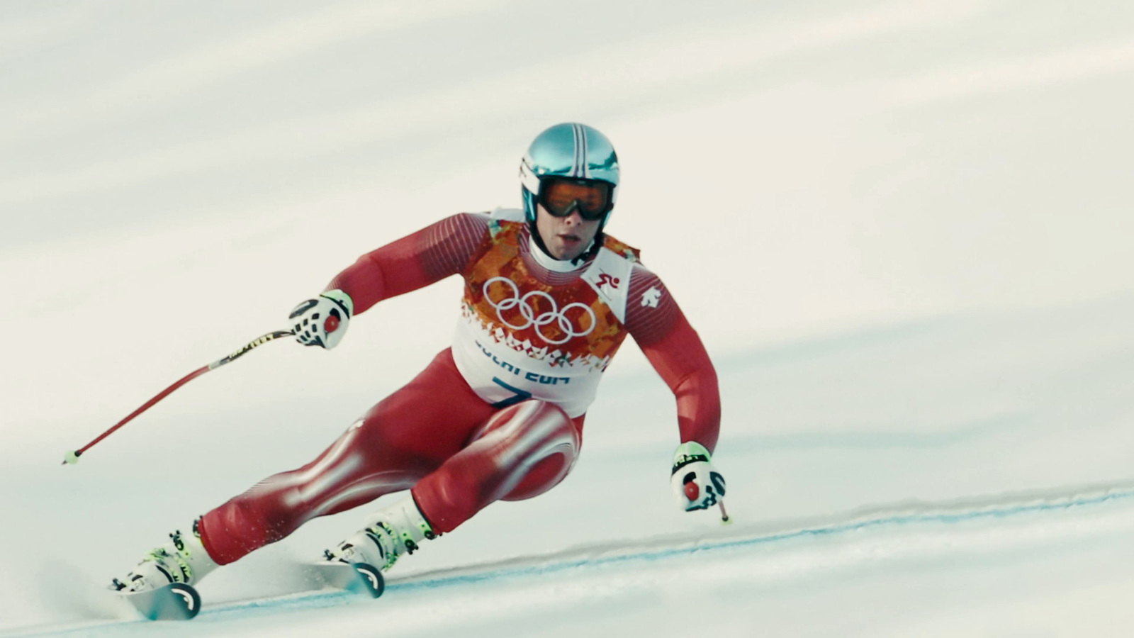 a man riding skis down a snow covered slope