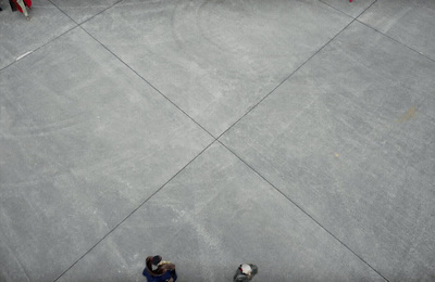 a group of people standing on top of a cement ramp