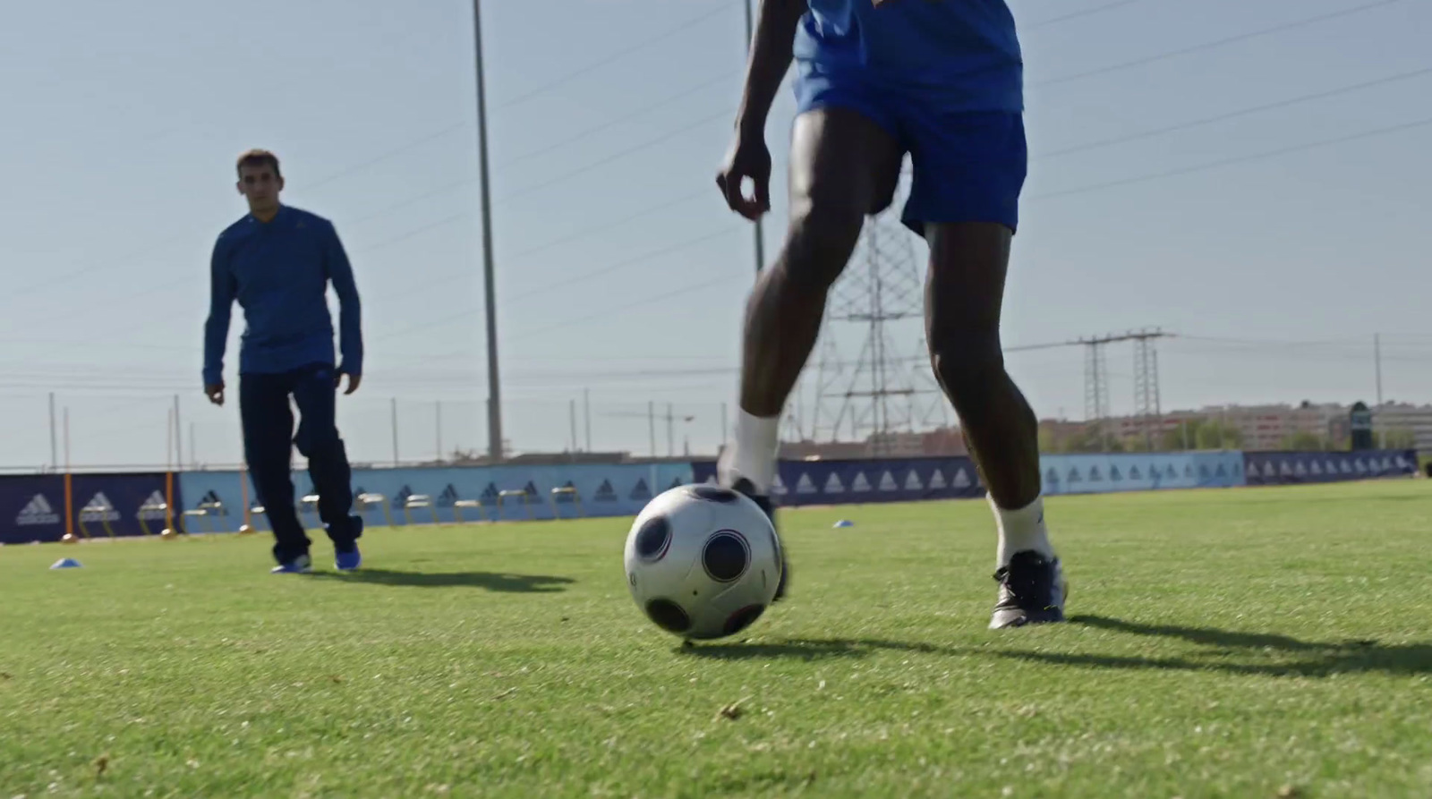 a man kicking a soccer ball on a field