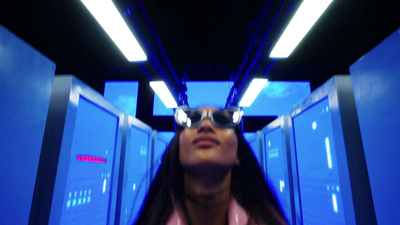 a woman wearing sunglasses standing in a blue room