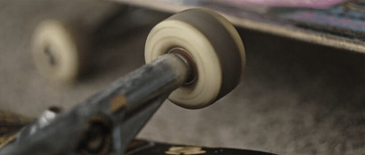 a close up of a skateboard with wheels on it