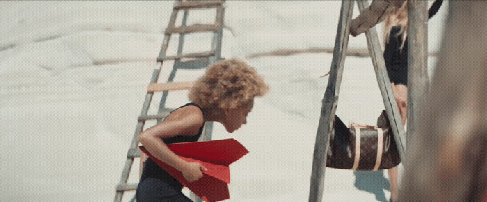 a woman with a red folder walking up a ladder