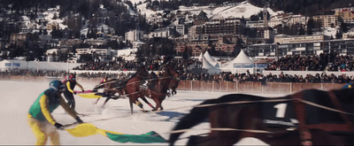 a group of people riding horses on a snow covered field