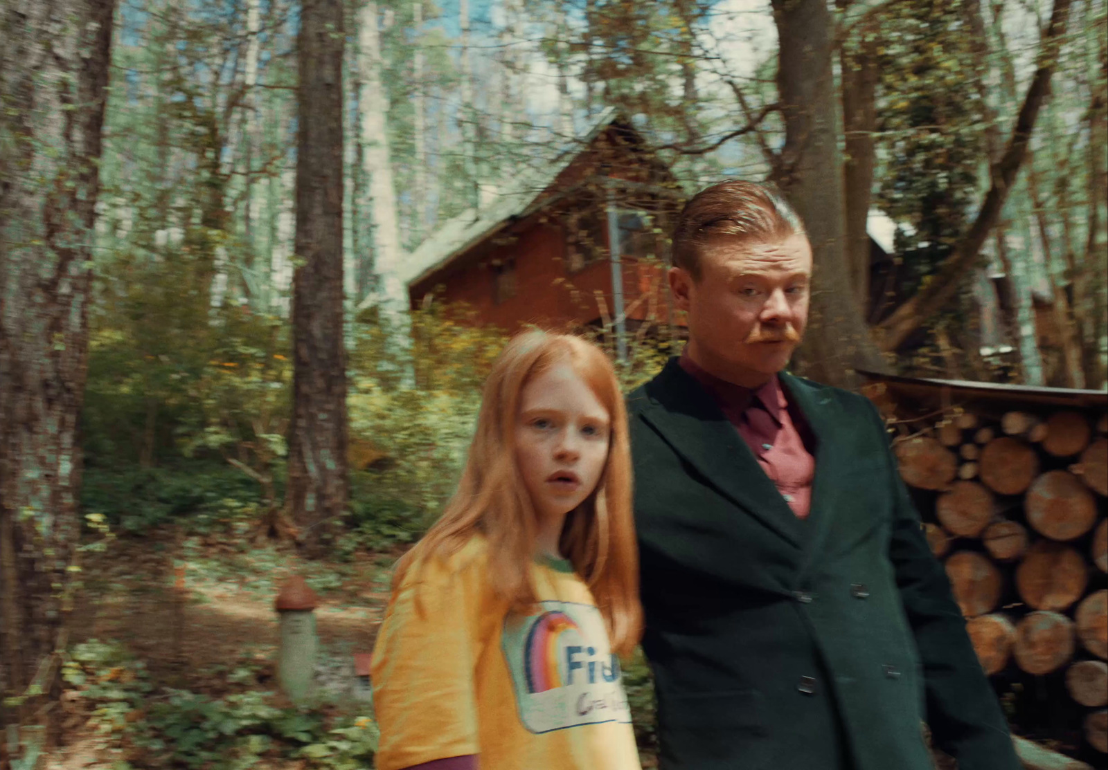 a man and a little girl standing in the woods