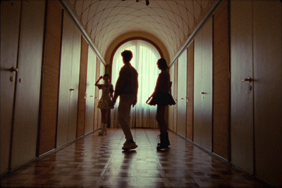 a couple of people standing in a hallway