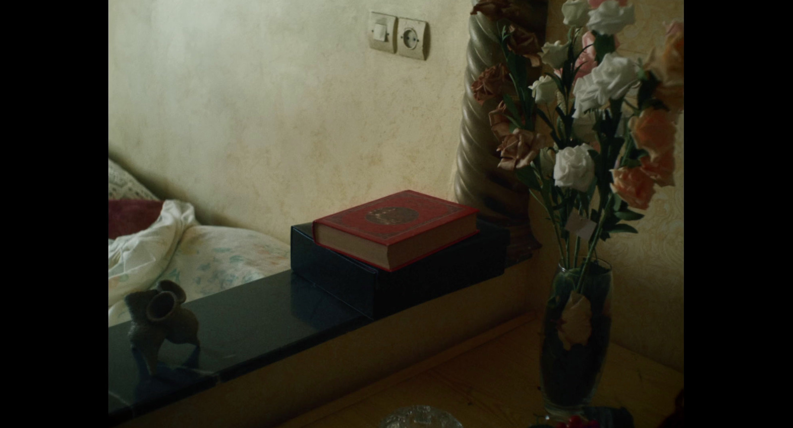a vase filled with flowers sitting on top of a table