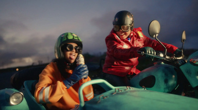 a couple of people riding on the back of a motorcycle