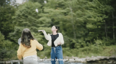 a man and a woman are flying a kite