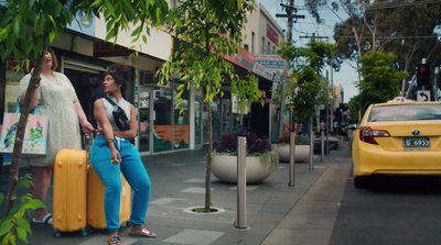 a couple of women standing next to each other on a street