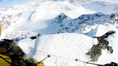 a man on skis standing on top of a snow covered mountain