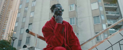 a man in a red jacket talking on a cell phone