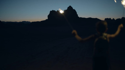 a person holding a sparkler in the dark