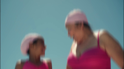 a blurry photo of two women wearing pink hats