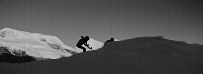 a black and white photo of a person on a snowboard