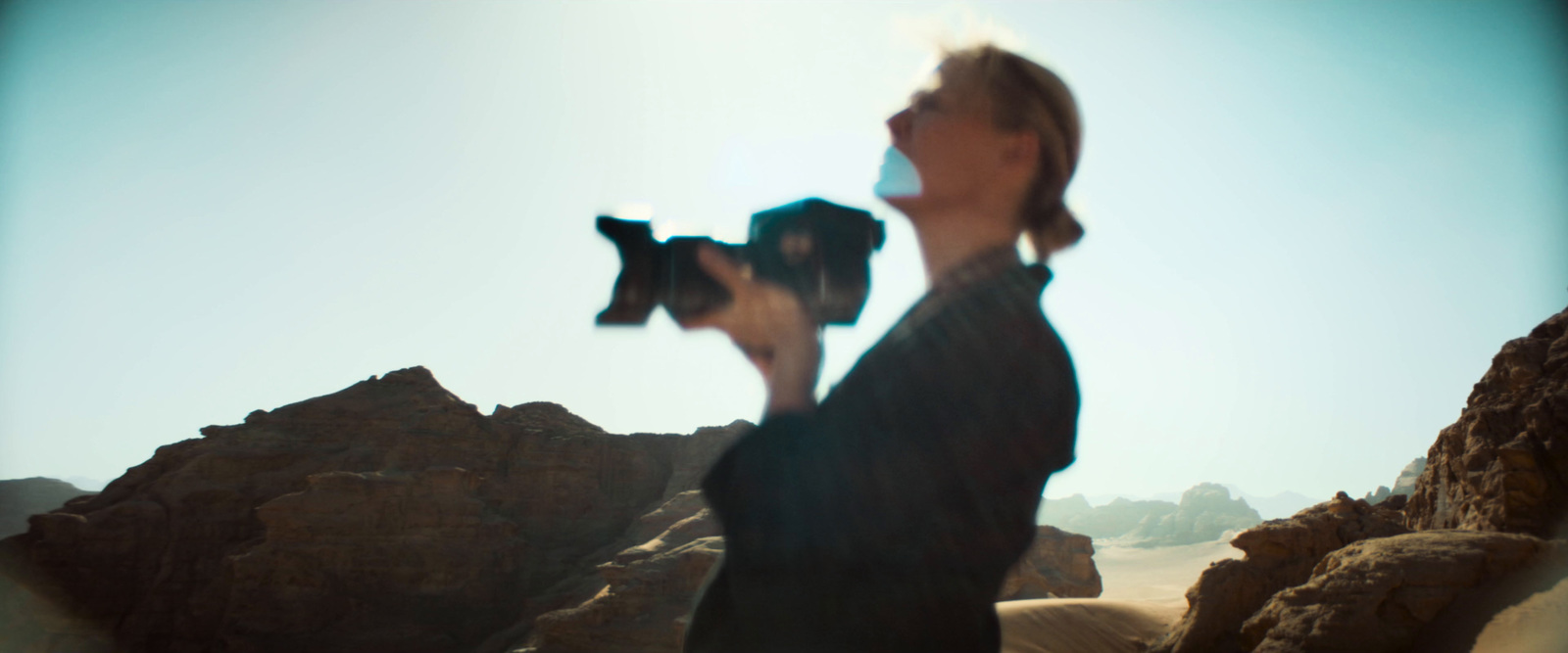 a woman holding a small dog in her hands