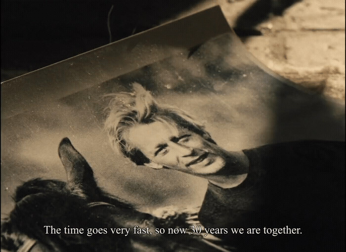 a black and white photo of a man and a dog