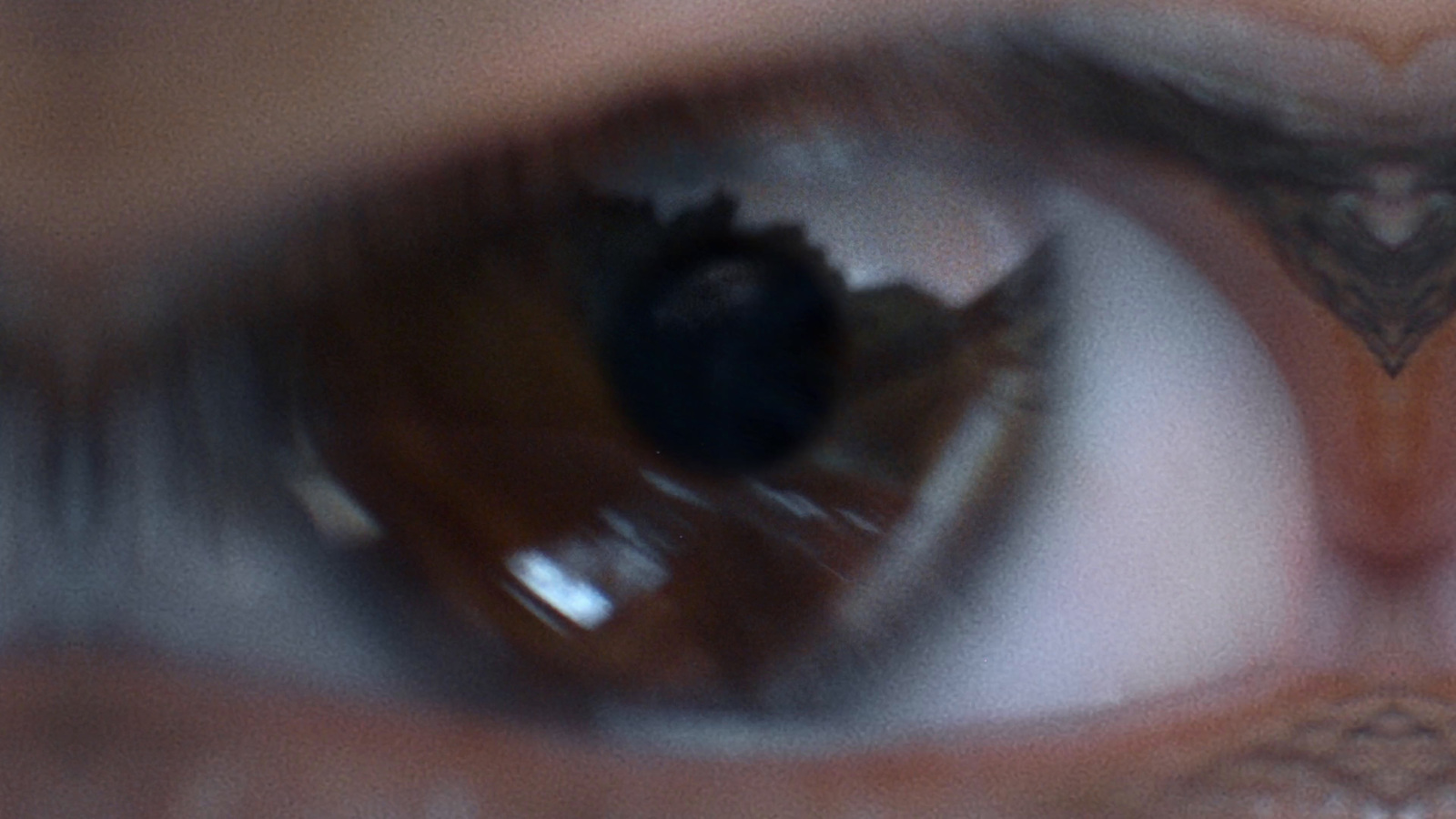 a close up of a person's eye with a blurry background