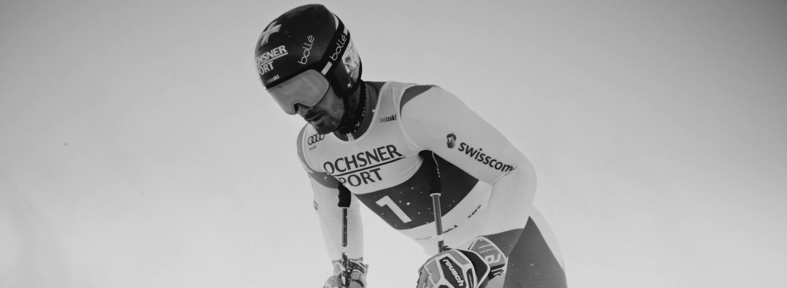 a man riding skis down a snow covered slope