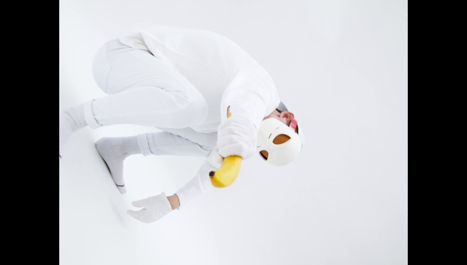 a person in a white outfit doing a trick on a skateboard