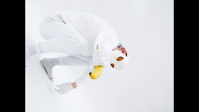 a person in a white outfit doing a trick on a skateboard