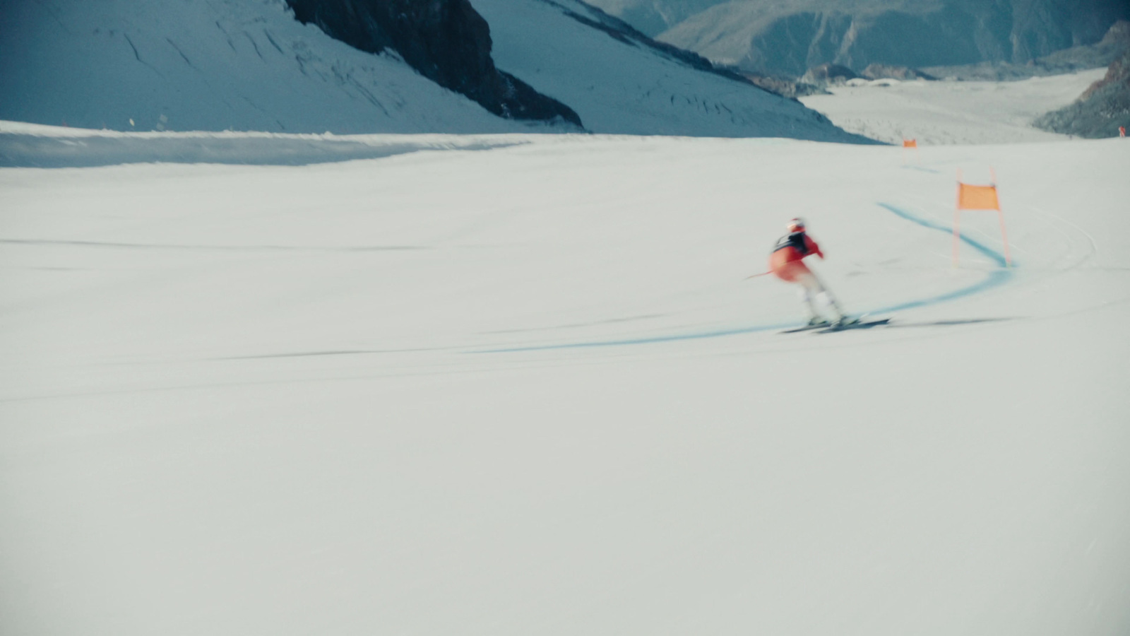 a person riding skis down a snow covered slope