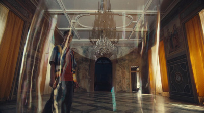 a blurry photo of two people walking down a hall