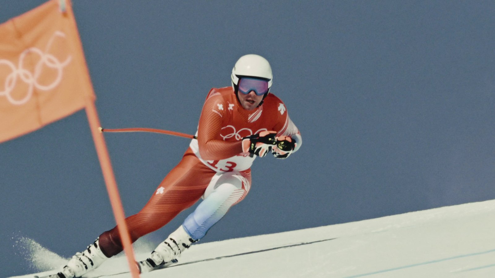 a man riding skis down a snow covered slope