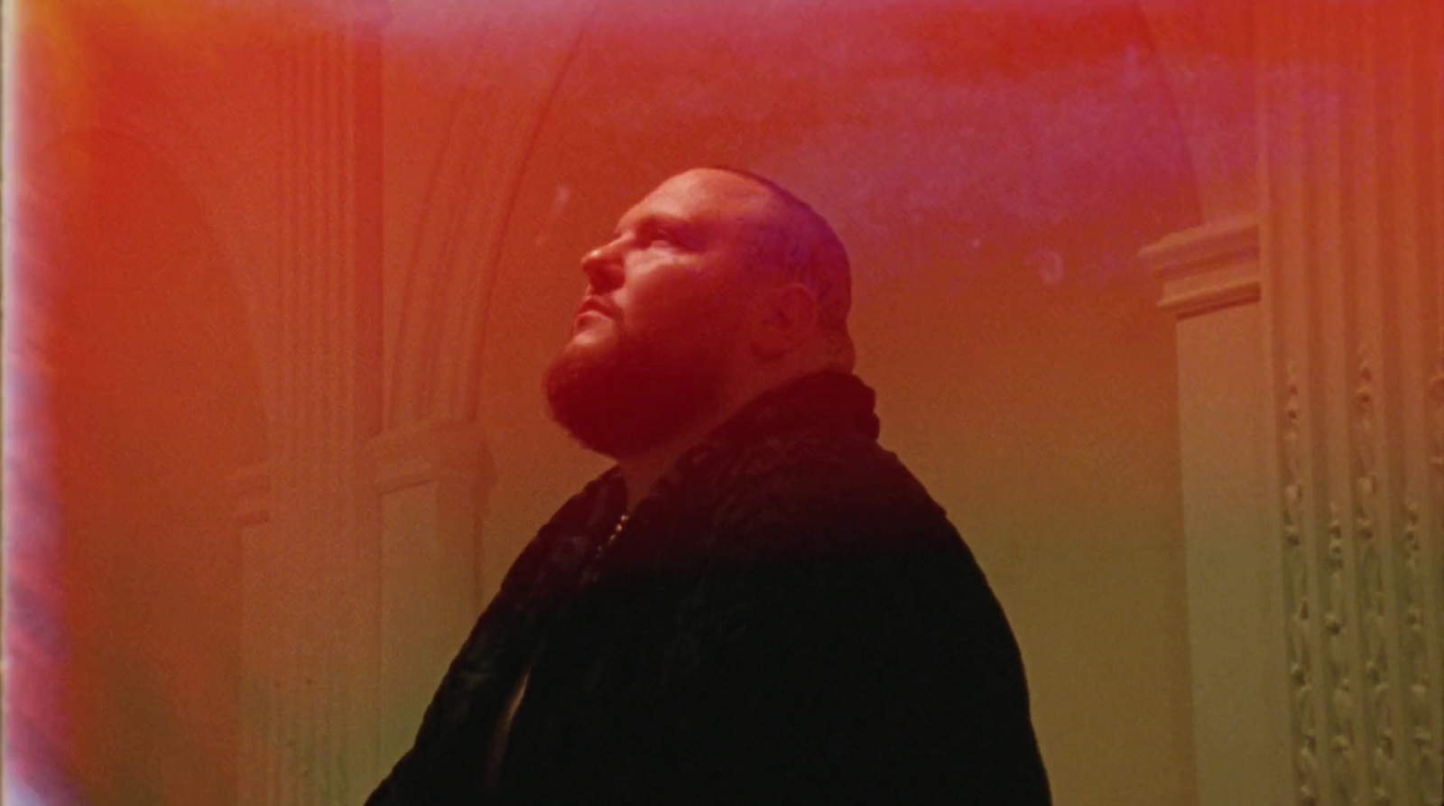 a man with a beard standing in a room